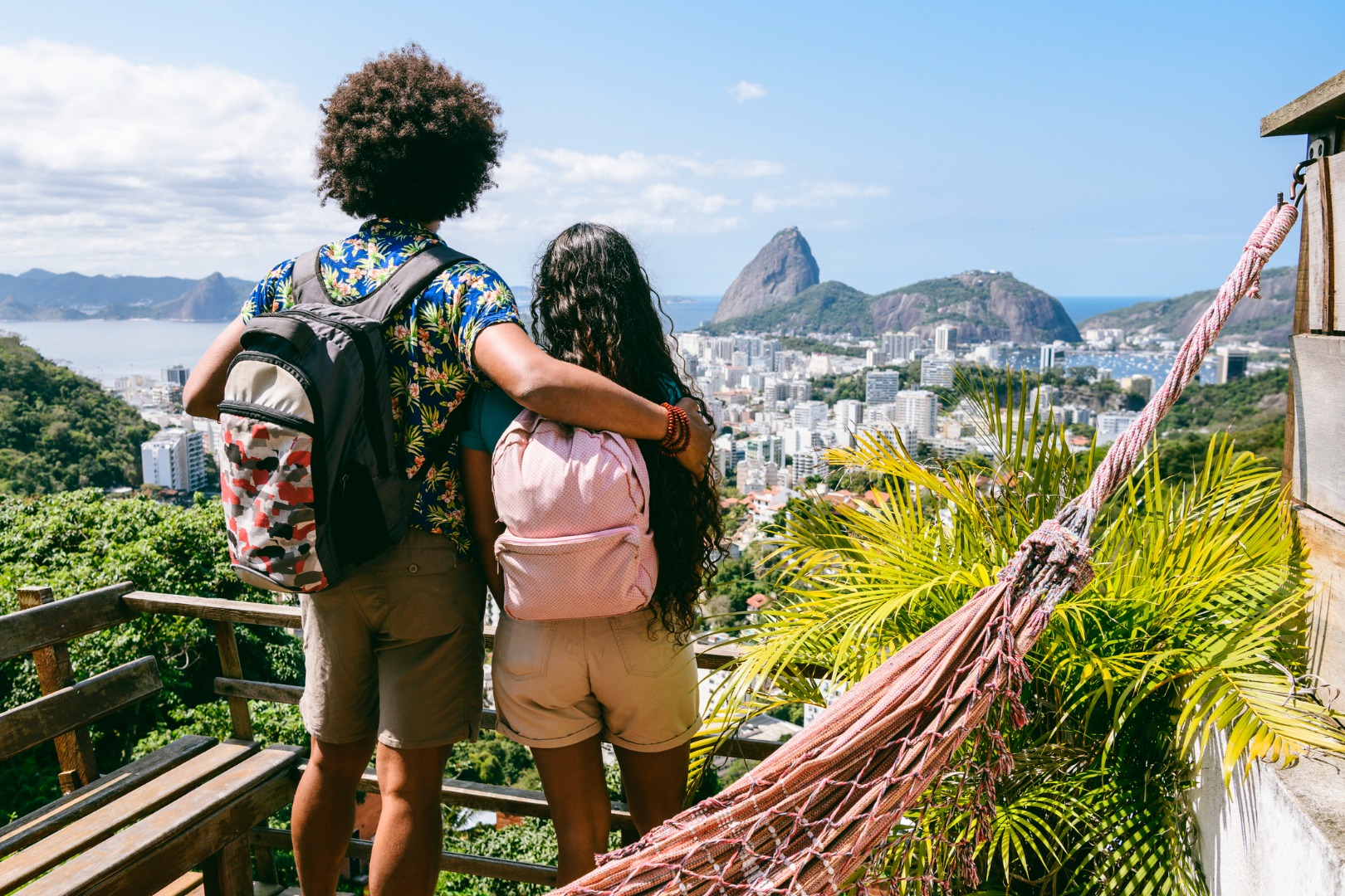 Rear view of two backpackers looking at view of Sugar Loaf Mountain